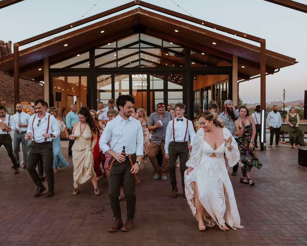 couple and their guests dancing during reception at Red Earth venue