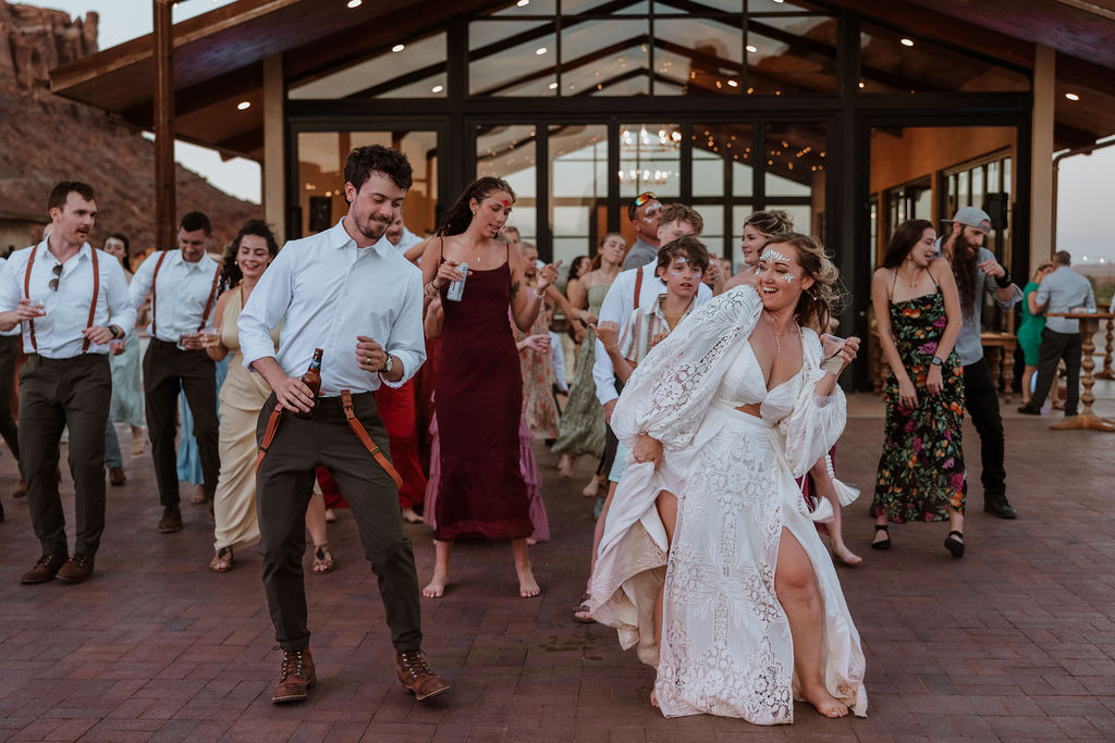 couple and their guests dancing during reception at Red Earth venue