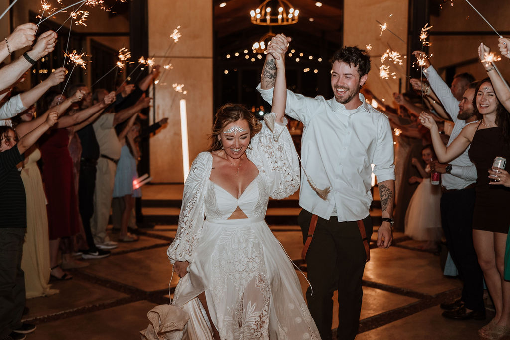 bride and groom smiling during sparkler send off  