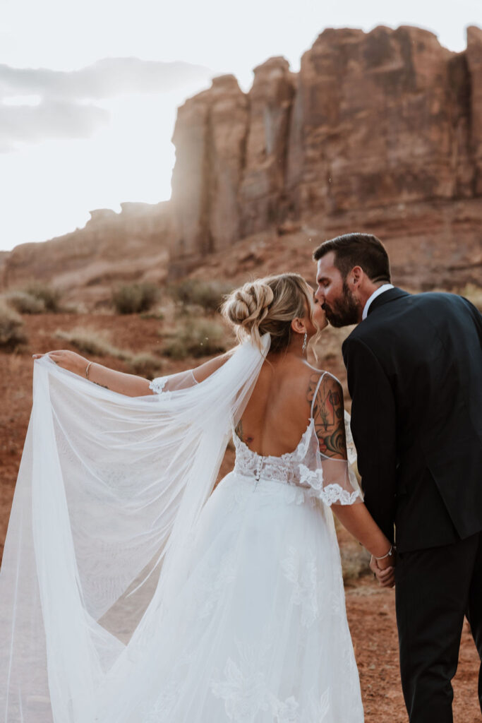 couple kissing during Moab sunset 