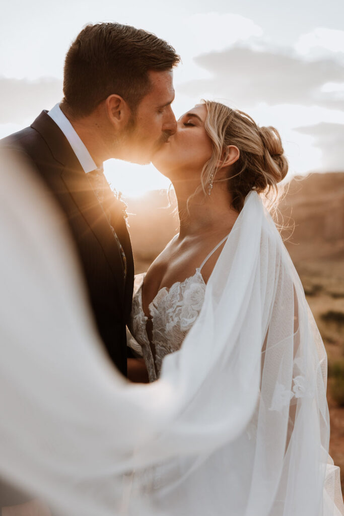 couple kiss during sunset in Moab