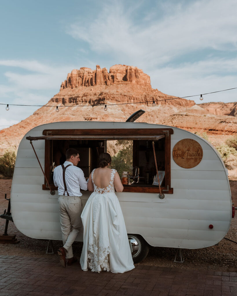 couple get drinks a mini camper called the Tipsy Trailer
