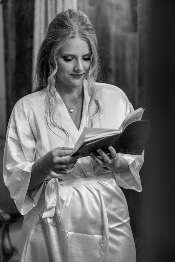 bride getting ready reading vow book