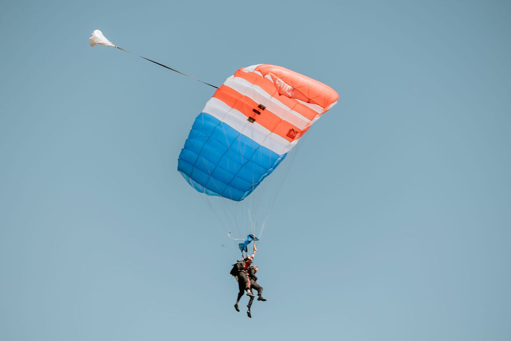 groom entering ceremony by parachute