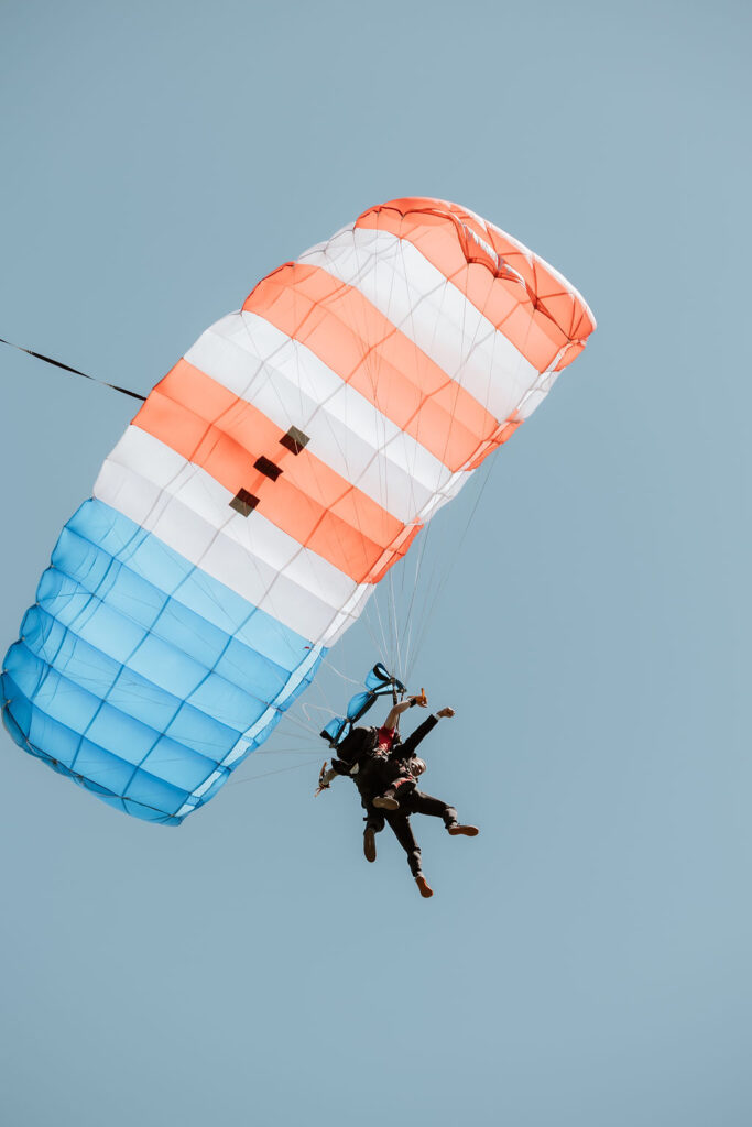 groom entering ceremony by parachute
