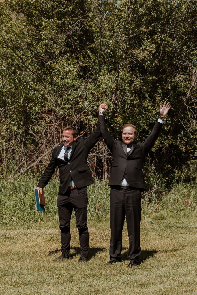 groom and officiant celebrate landing together 