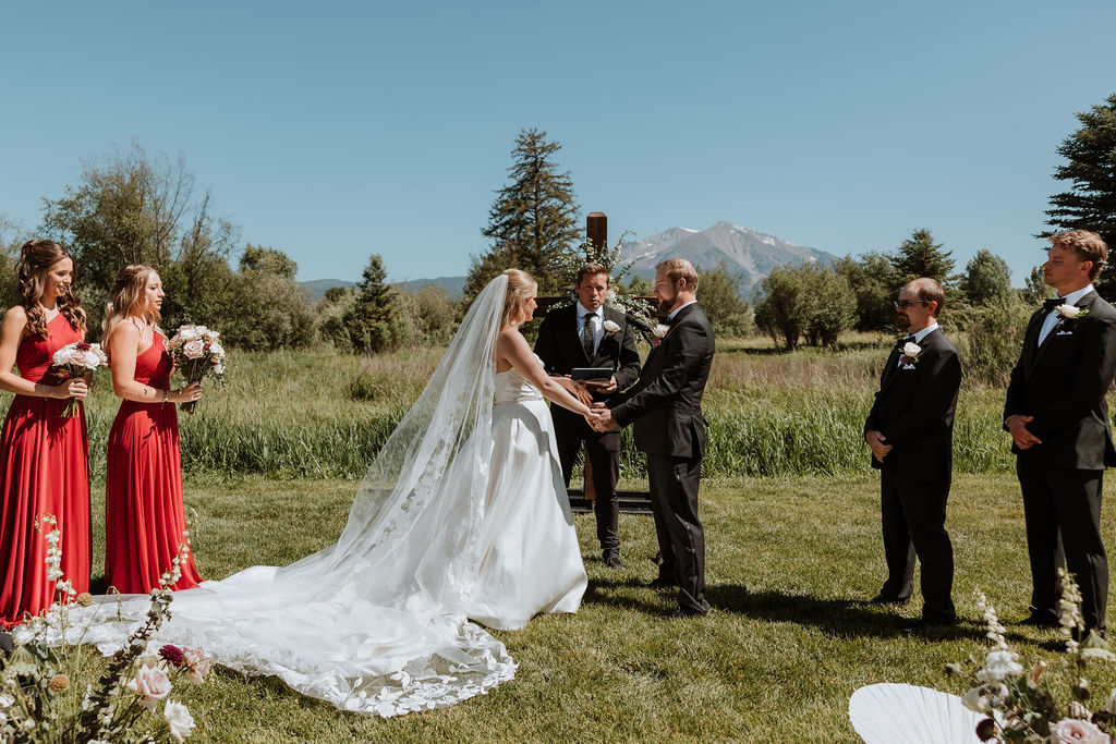 couple hold hands during ceremony at Spring Creeks Ranch