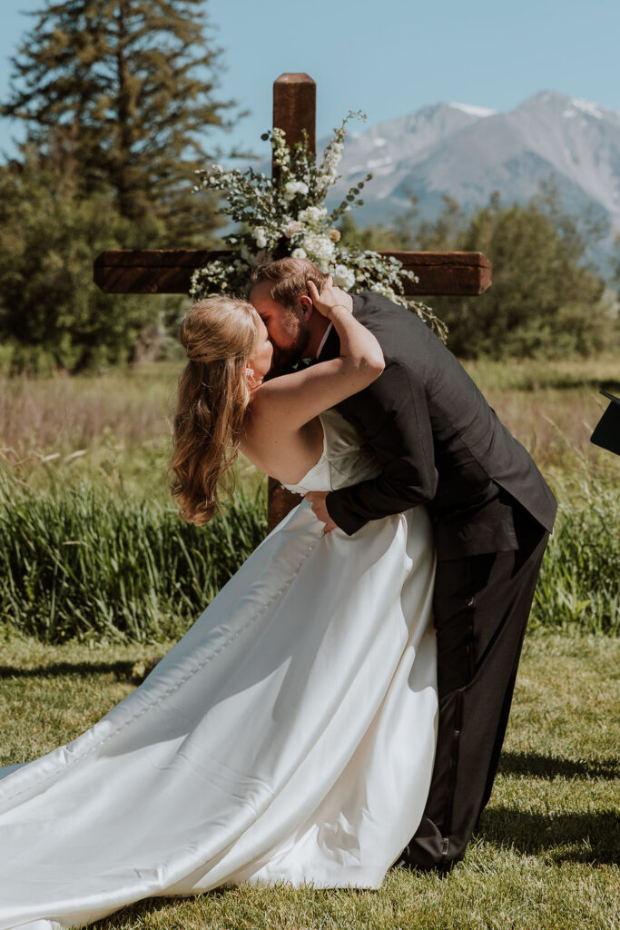couple kiss at ceremony at Spring Creeks Ranch