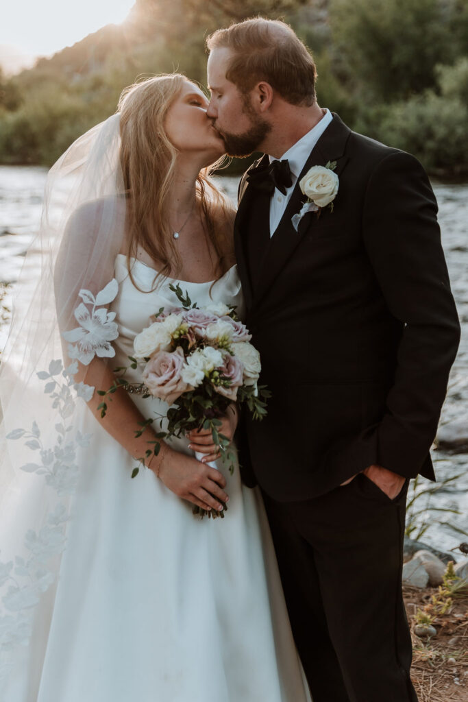 couple pose along river at Spring Creeks Ranch
