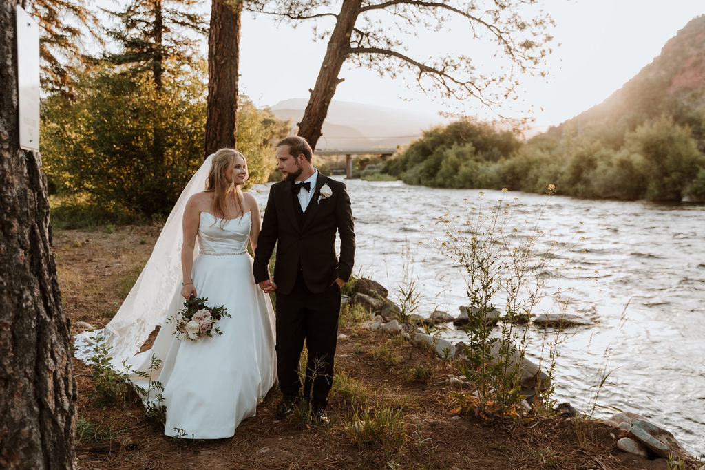 couple walks along river at Spring Creeks Ranch