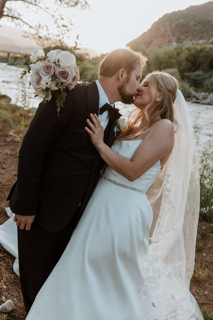 couple pose along river at Spring Creeks Ranch