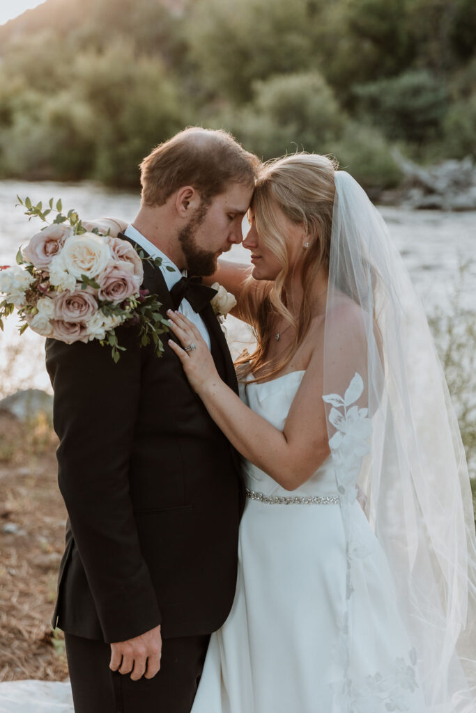 couple pose along river at Spring Creeks Ranch