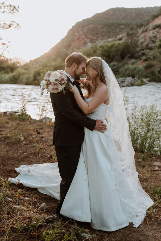 couple pose along river at Spring Creeks Ranch