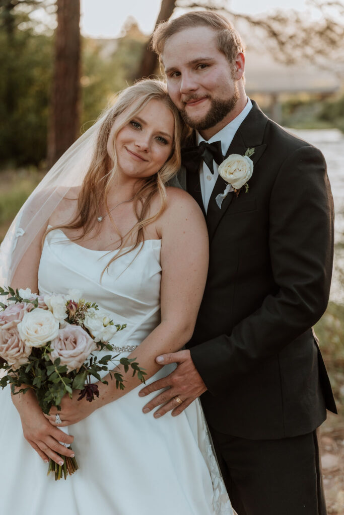 couple pose with creek in background at Spring Creeks Ranch