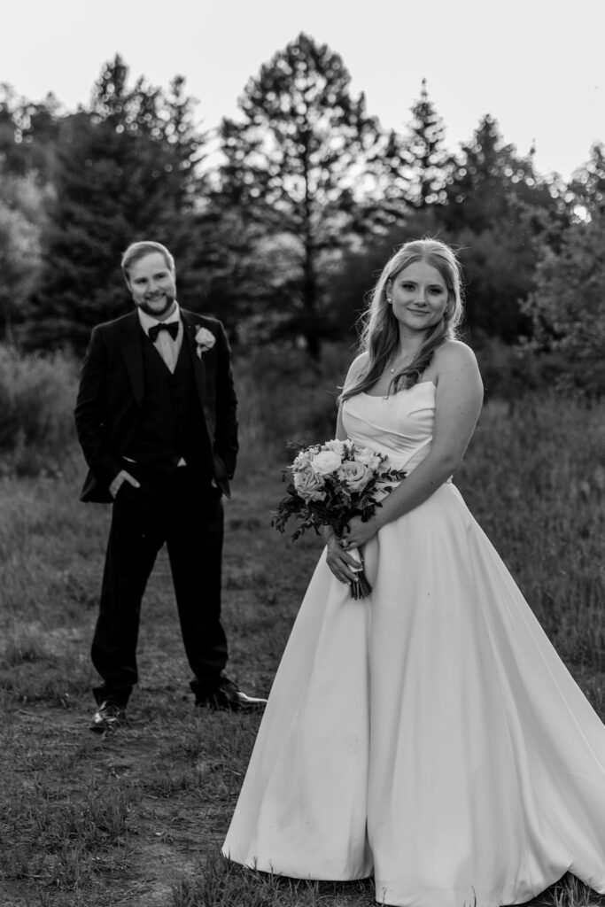 couple pose in grassy meadows of Spring Creeks Ranch