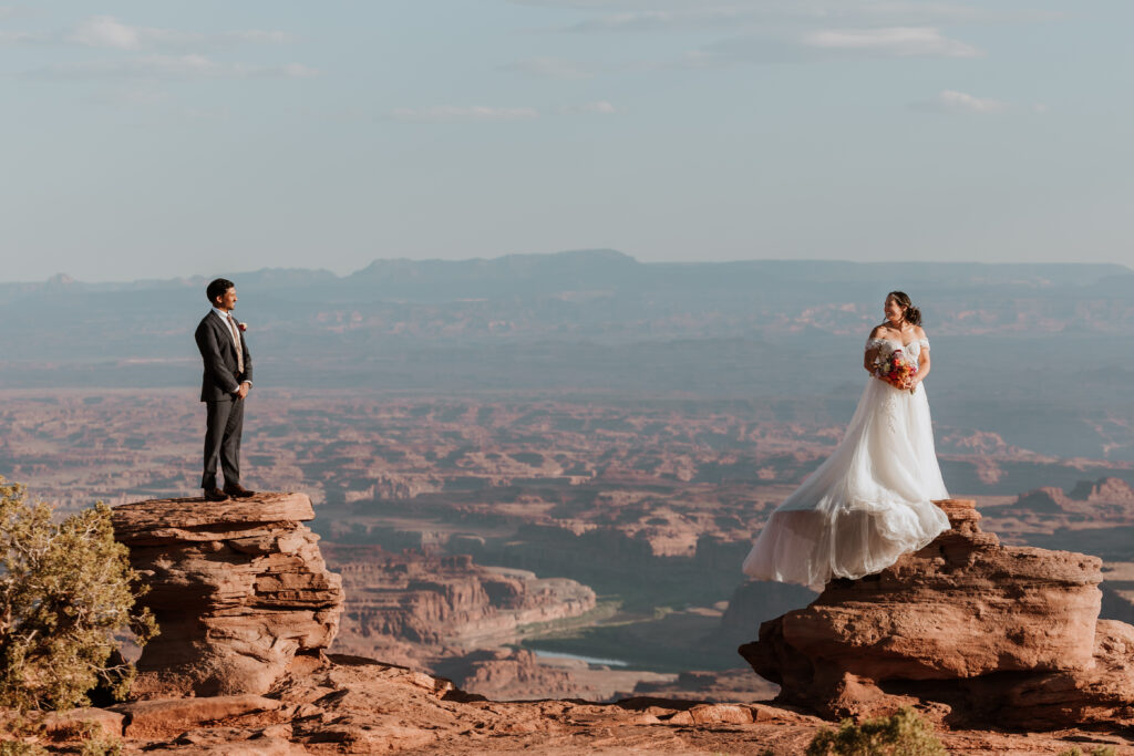 bride and groom stand on rock structures