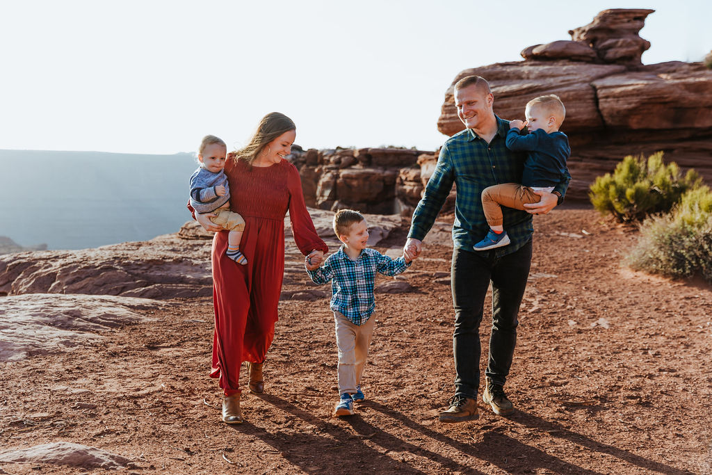family walks along rocky path of Moab hiking trails