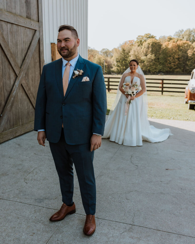 couple stand apart waiting to do their wedding first look