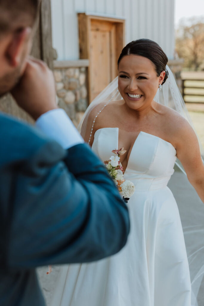 bride smiles after during wedding first look