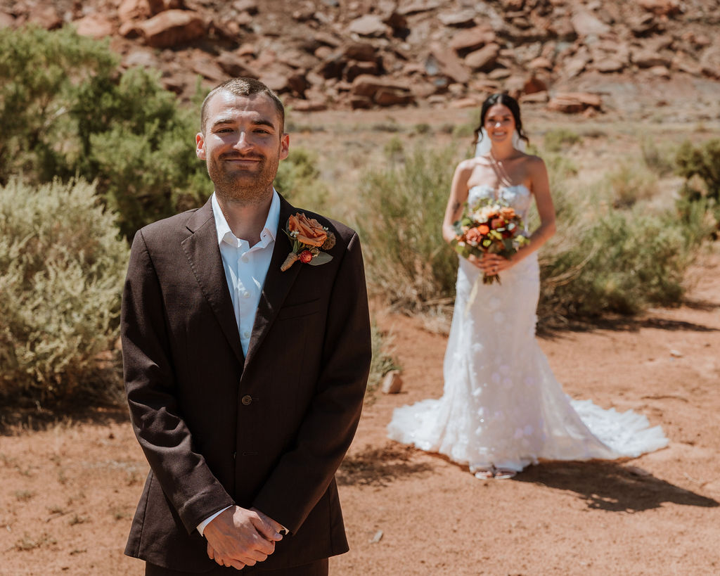 couple stand apart waiting to do their wedding first look