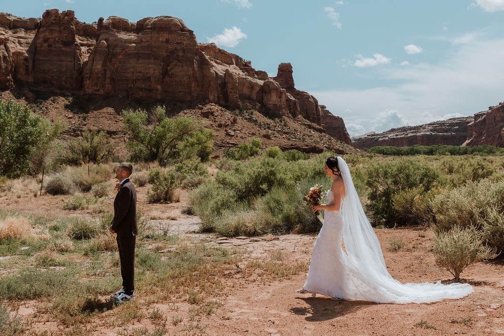 couple stand apart waiting to do their wedding first look