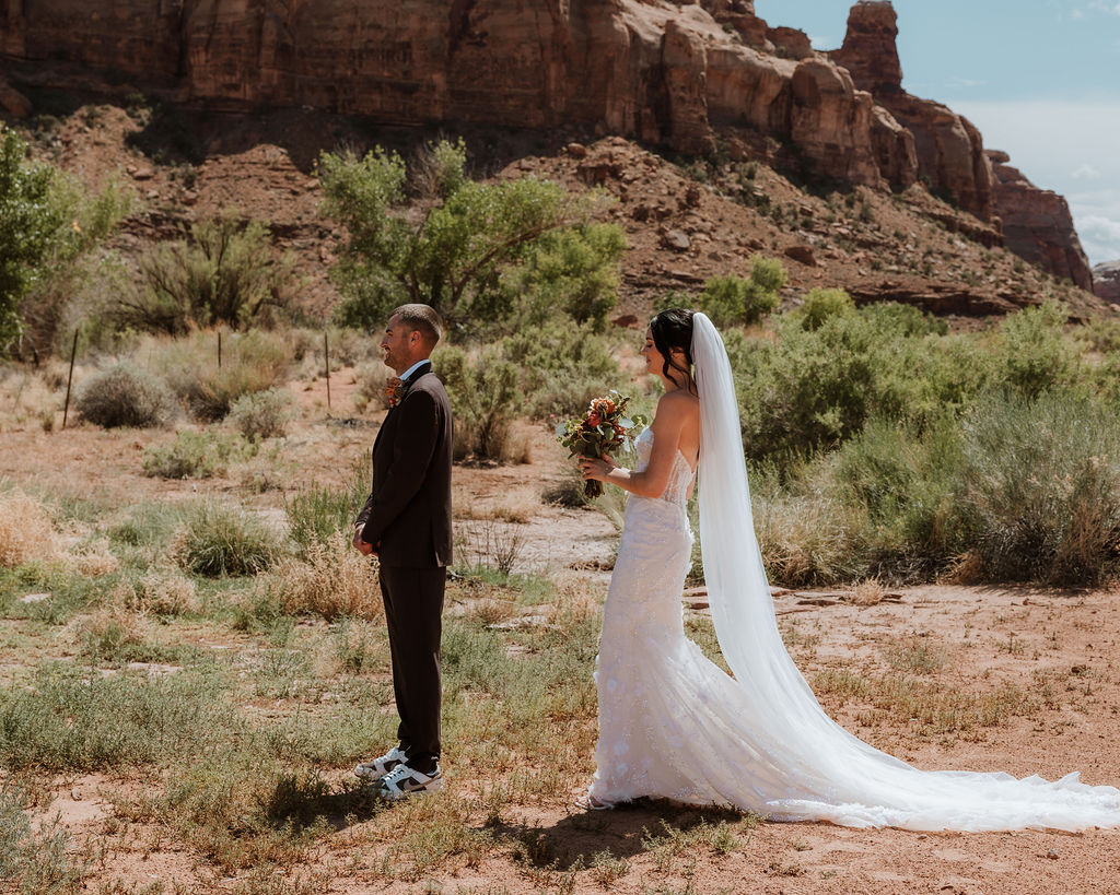 couple stand apart waiting to do their wedding first look