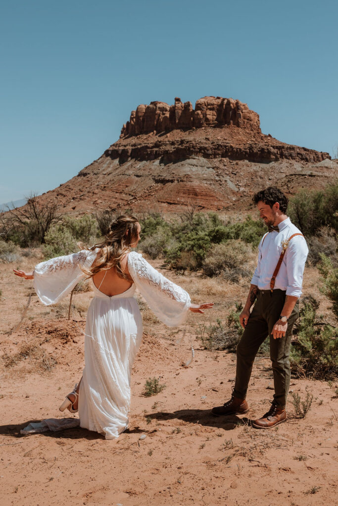 bride spins around to show off dress during wedding first look