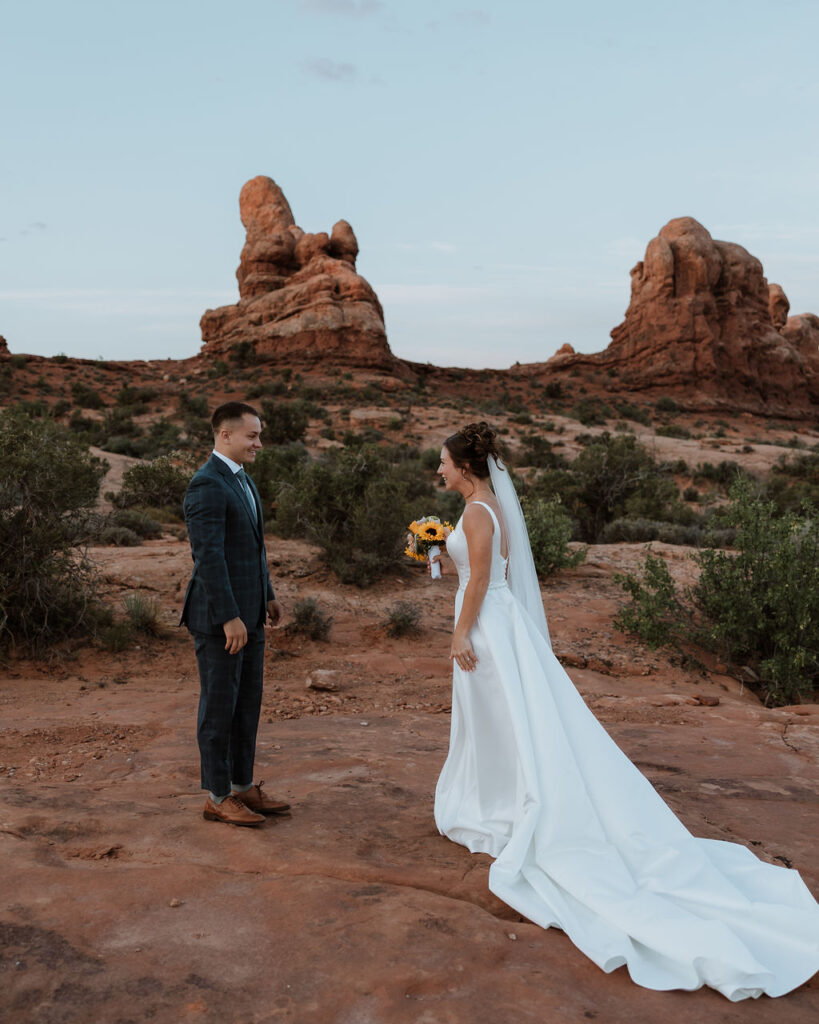 couple stand apart waiting to do their wedding first look